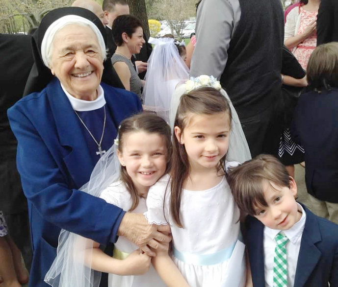 Sister Mary Angelus shares a special moment during a First Holy Communion celebration at St. Peter Church in Warwick.